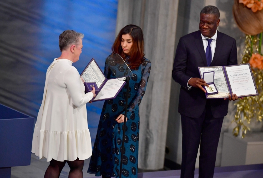 Chairman of the Norwegian Nobel Committee Berit Reiss-Andersen awards the prizes to Iraqi Yazidi-Kurdish human rights activist and co-laureate of the 2018 Nobel Peace Prize Nadia Murad and Congolese gynecologist and co-laureate of the 2018 Nobel Peace Prize Denis Mukwege during the Nobel Peace Prize ceremony on Monday at the City Hall in Oslo, Norway. — AFP