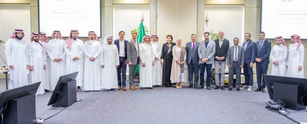 Dr. Abdul-Aziz Al-Ruwais, Governor of CITC, and Paul Rendek, Director of External Relations, RIPE NCC, pose for a group photo with other participants in the meeting 