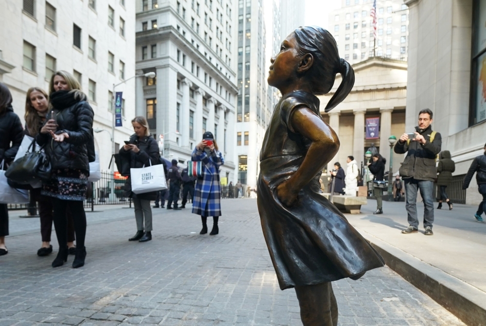The Fearless Girl statue is unveiled at her new home facing the New York Stock Exchange (NYSE) during an event held by the city of New York and State Street Global Advisers. — AFP