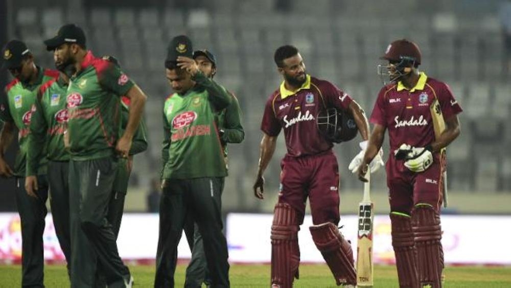 Bangladesh and West Indies players walk off the ground after the visitors win in Dhaka that leveled the ODI series.