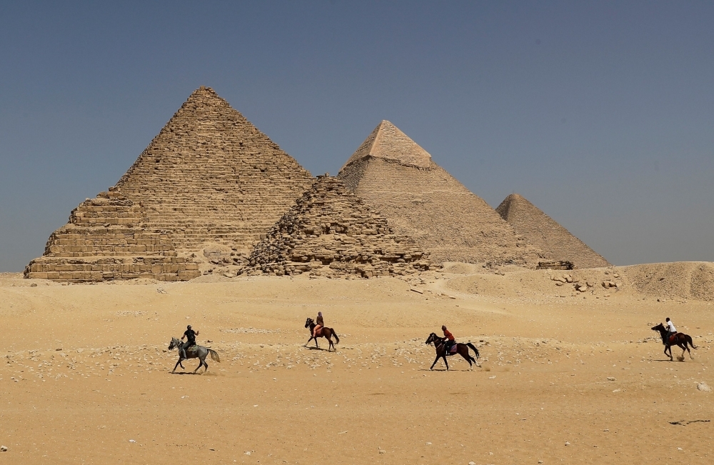Horse riders gallop near the Giza pyramids, on the southwestern outskirts of the Egyptian capital Cairo, in this Oct. 02, 2018 file photo. — AFP