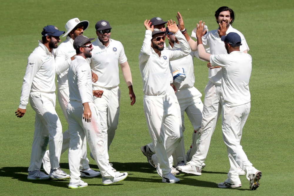 India's captain Virat Kohli (C) celebrates with his teammates after taking the catch to dismiss Australia's Peter Handscomb (not pictured) on day one of the second test match between Australia and India at Perth Stadium in Perth, Australia, on Friday. — Reuters