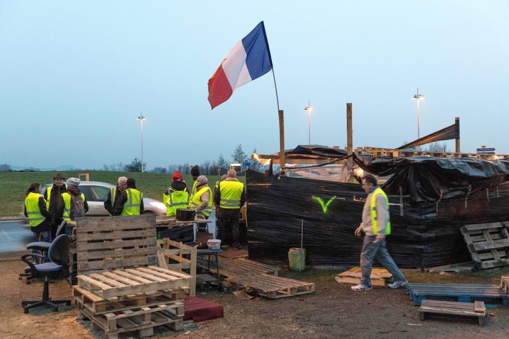 Protesters wearing yellow vests (gilets jaunes) occupy the 