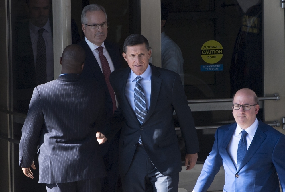 Gen. Michael Flynn, center, former national security adviser to US President Donald Trump, leaves Federal Court in Washington in this Dec. 1, 2017 file photo. — AFP