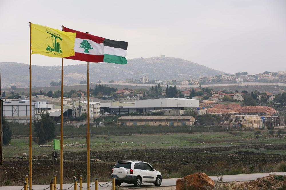 Flags of Hezbollah, Lebanon and Palestine are seen fluttering near the border with Israel in the village of Khiam, Lebanon. — Reuters