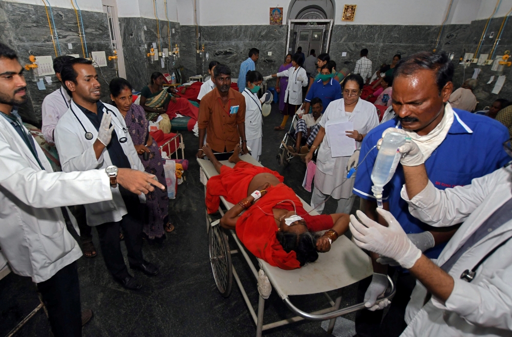 Medics tend to people who were hospitalized after consuming a religious food offering at a temple, inside hospital in the southern city of Mysuru, India, in this Dec. 14, 2018 file photo. — Reuters