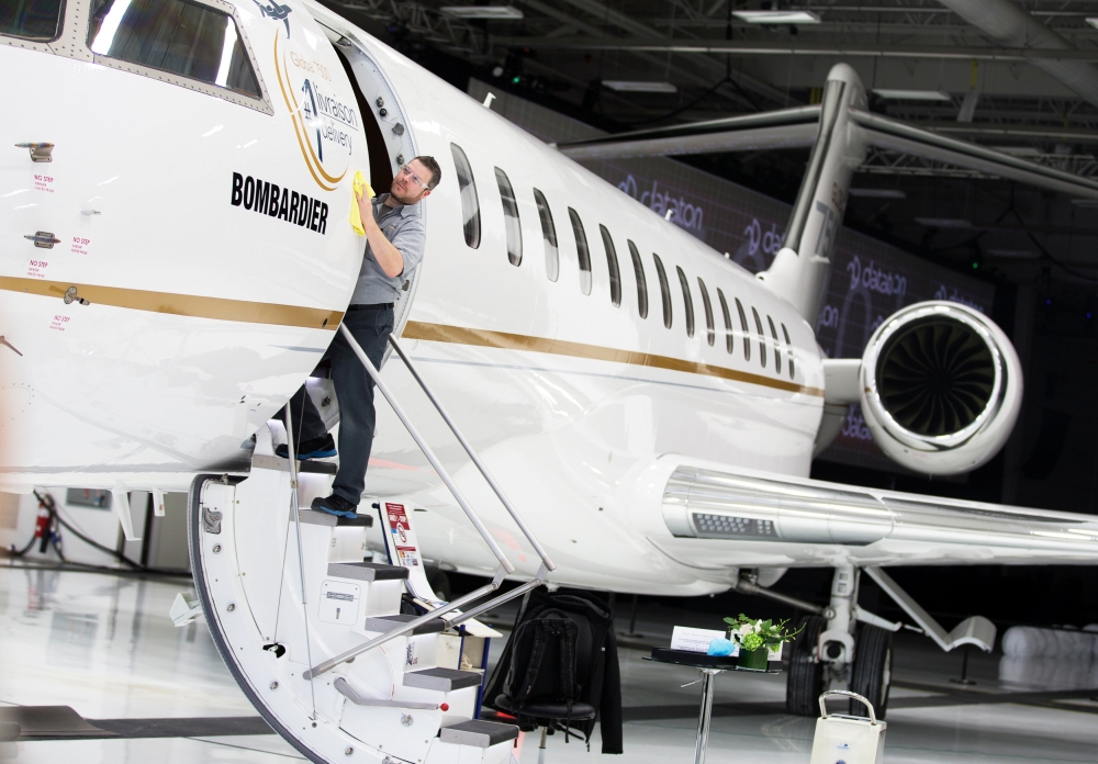 Bombardier employee Francis Masse polishes the sign of Bombardier’s Global 7500, the first business jet to have a queen-sized bed and hot shower, is shown during a media tour in Montreal, Quebec, Canada, on Wednesday. —