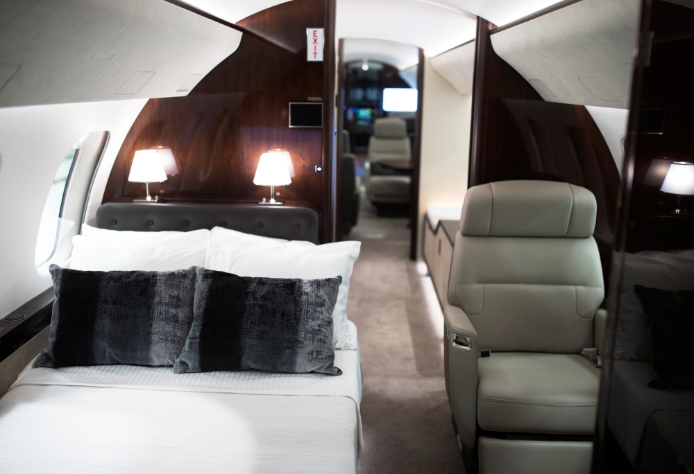 Bombardier employee Francis Masse polishes the sign of Bombardier’s Global 7500, the first business jet to have a queen-sized bed and hot shower, is shown during a media tour in Montreal, Quebec, Canada, on Wednesday. —