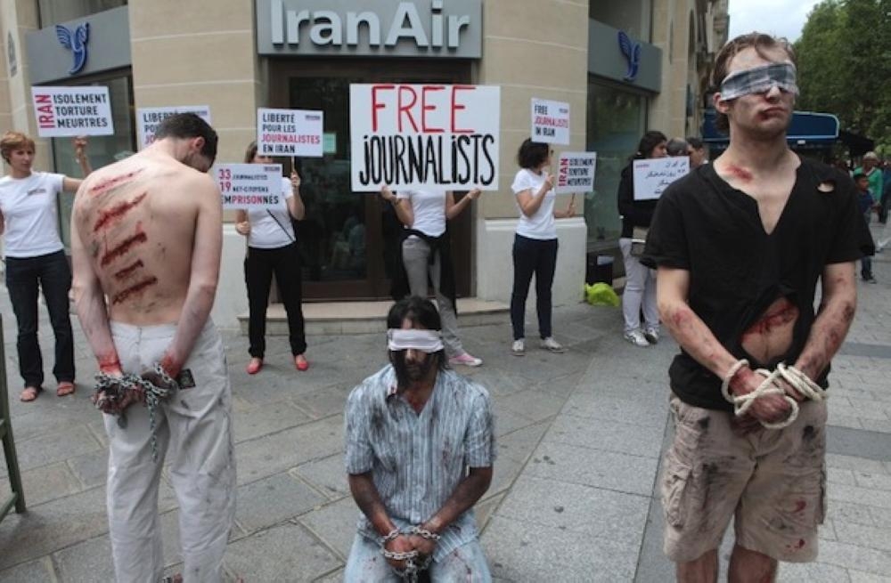 Reporters Without Borders (Reporters Sans Frontieres- RSF) activists take part in a protest in front of an Iran Air agency in Paris to denounce journalists' imprisonment in Iran. — AFP file photo