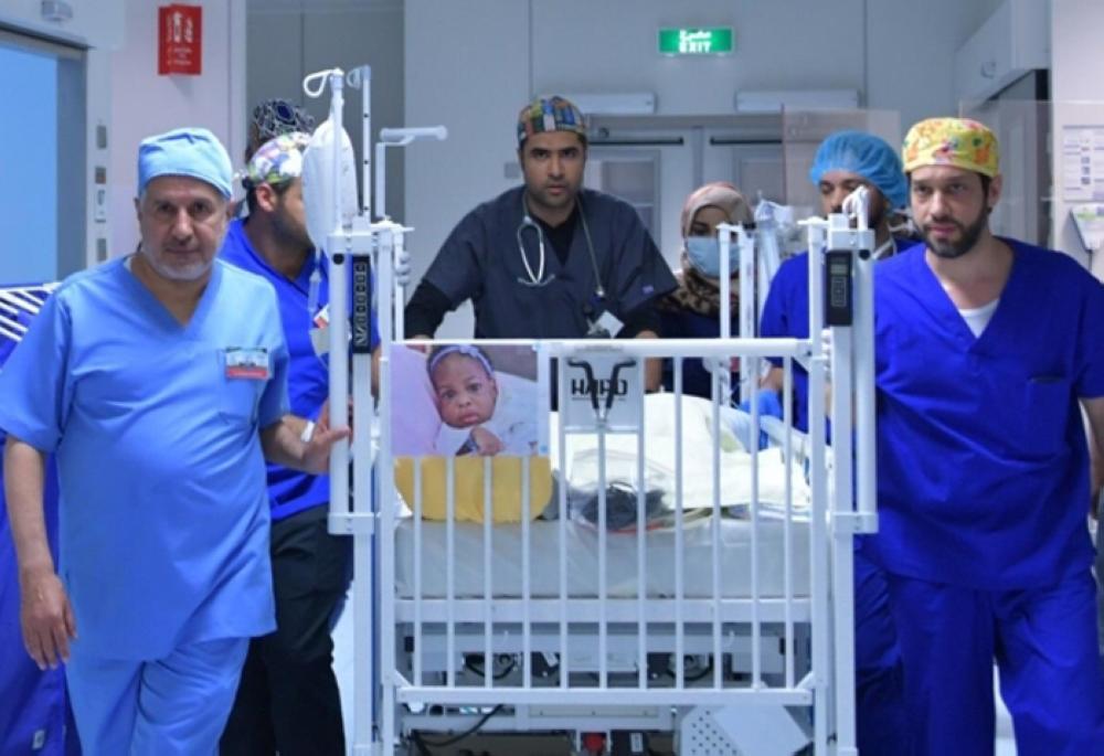 Dr. Abdullah Al-Rabeeah and his team with the Tanzanian twins following their successful separation.