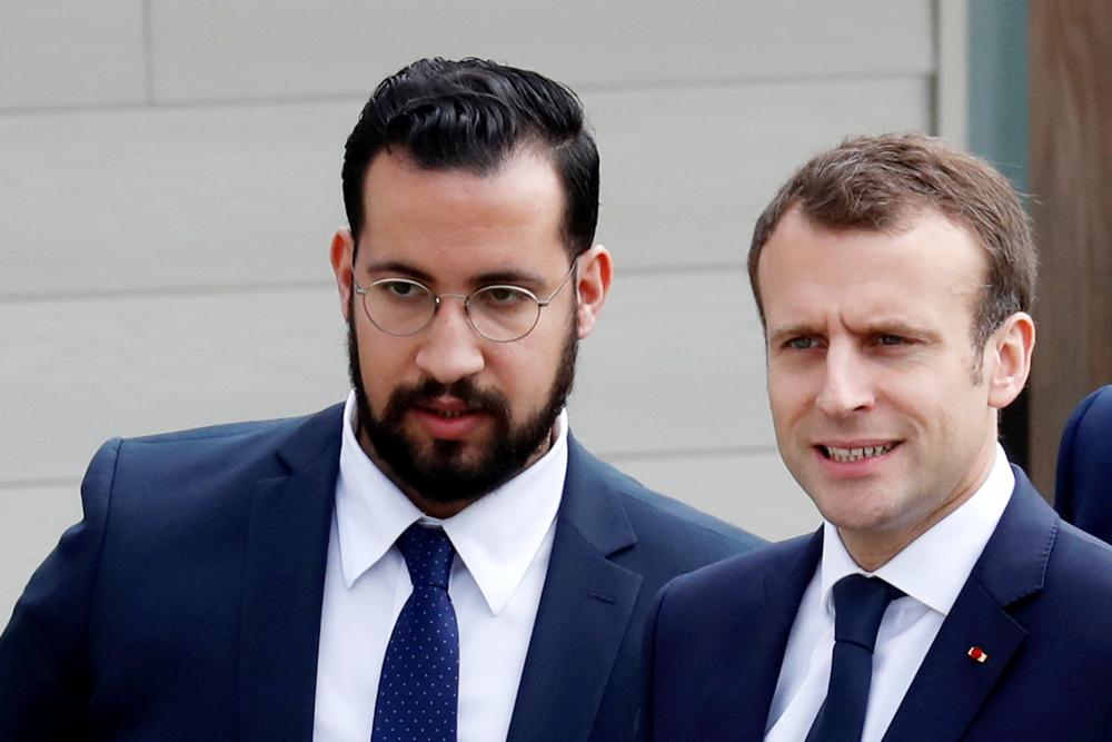 French President Emmanuel Macron and his then senior security officer Alexandre Benalla arrive at an elementary school to attend a one-hour interview with French news channel TF1, in Berd’huis, France, in this April 12, 2018 file photo. — Reuters
