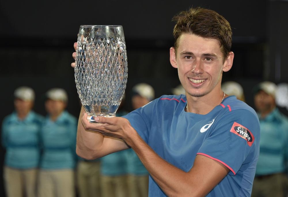 Australia’s Alex De Minaur holds the trophy after beating Andreas Seppi of Italy in the final at the Sydney International Tennis Tournament Saturday. — AFP 
