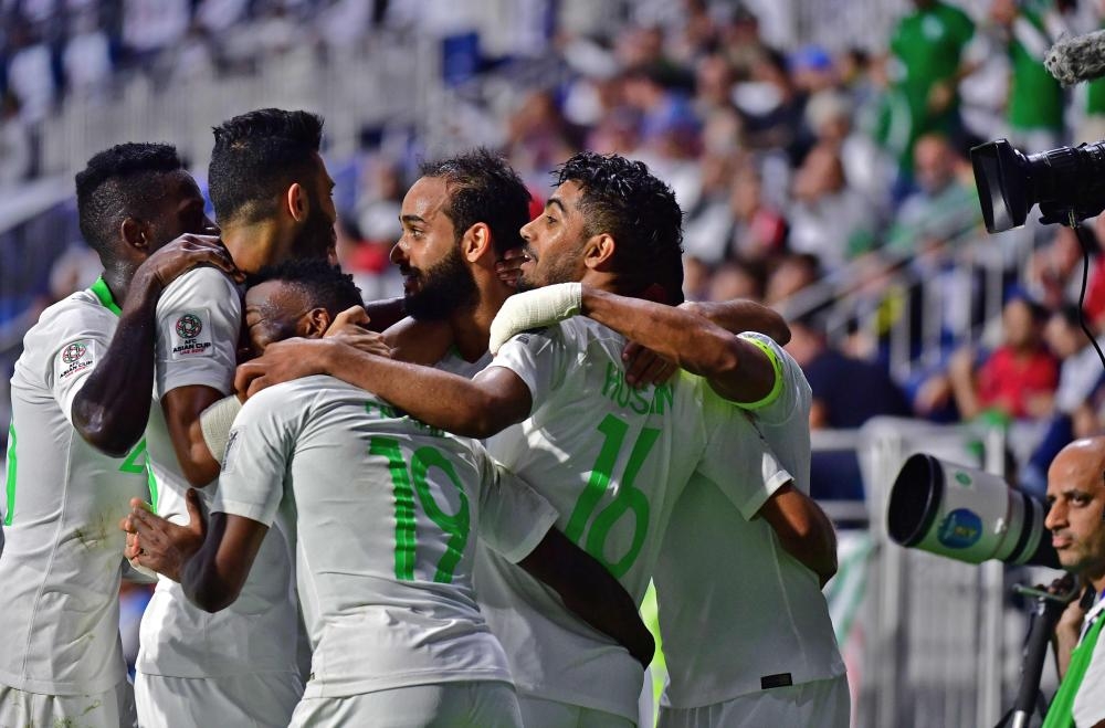 Saudi Arabia's midfielder Hussain Al-Moqahwi (R) celebrates after scoring a goal during the 2019 AFC Asian Cup Group E match against Lebanon at the Maktoum Bin Rashid Al-Maktoum Stadium in Dubai Saturday. — AFP