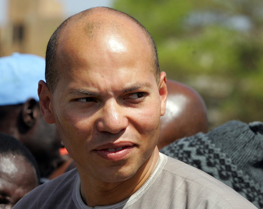 Karim Wade, son of Senegalese president Abdoulaye Wade and president of ANOCI (national agency for organizing of the Islamic conference) looks around upon arrival for the inauguration of the Soumbedioune tunnel in Dakar in this March 8, 2008 file photo. 