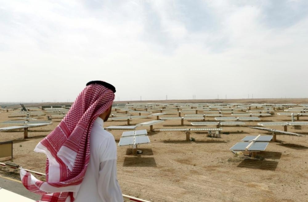 A Saudi man looks at the solar plant in Uyayna, north of Riyadh, in this file photo. — Reuters