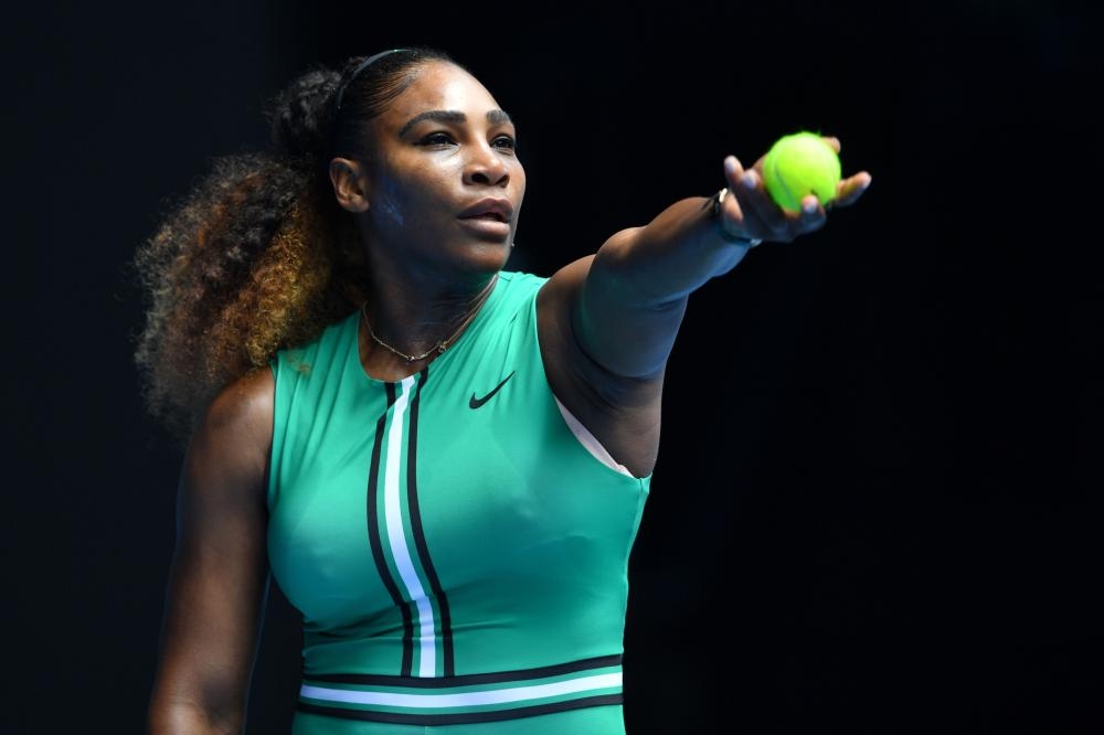 Serena Williams of the US serves against Germany’s Tatjana Maria during their match at the Australian Open in Melbourne Tuesday. — AFP
