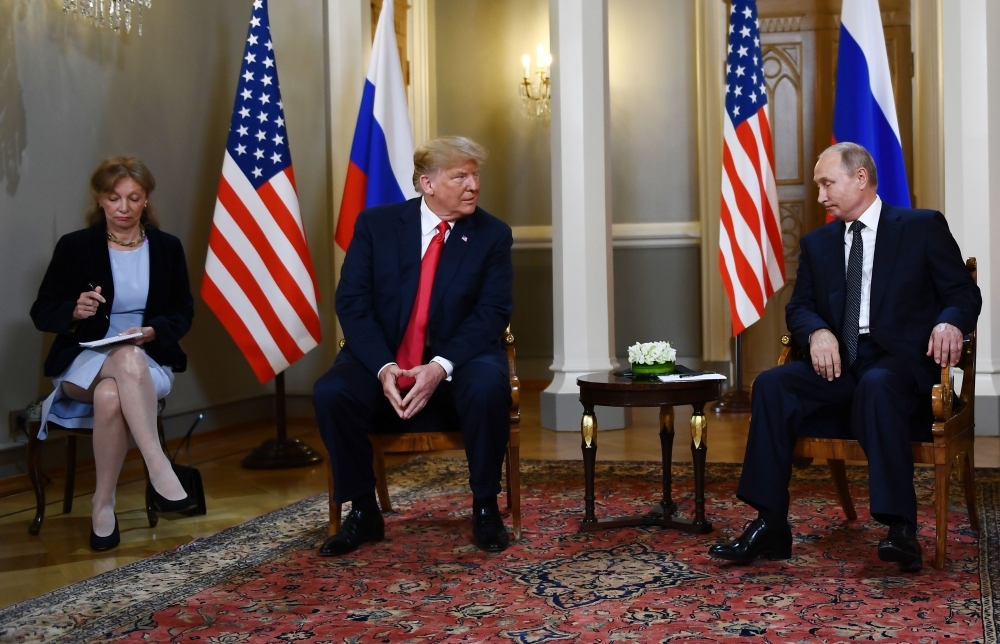 Russian President Vladimir Putin, right, and US President Donald Trump, second left, attend a meeting in Helsinki, in this July 16, 2018 file photo. — AFP