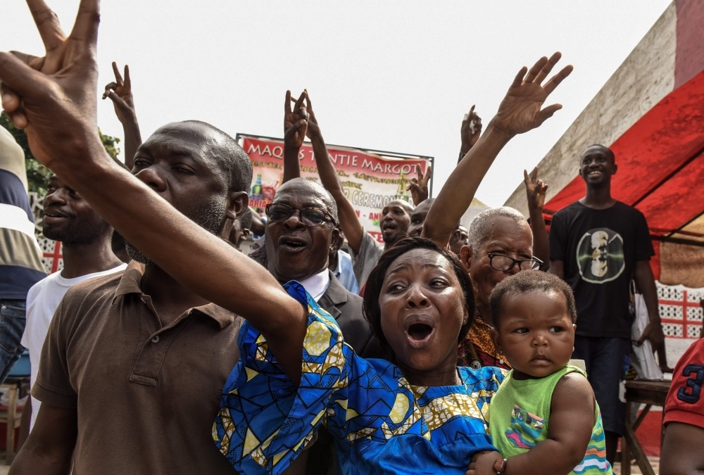 People celebrate in Abidjan on Tuesday after the news that International Criminal Court acquitted former Ivory Coast president Laurent Gbagbo over a wave of post-electoral violence, in a stunning blow to the war crimes tribunal in The Hague. — AFP