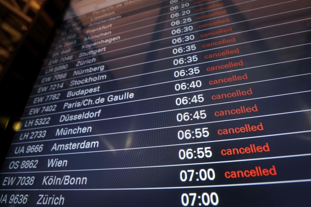 A board displays canceled flights at the airport in Hamburg, northern Germany, on Tuesday. — AFP