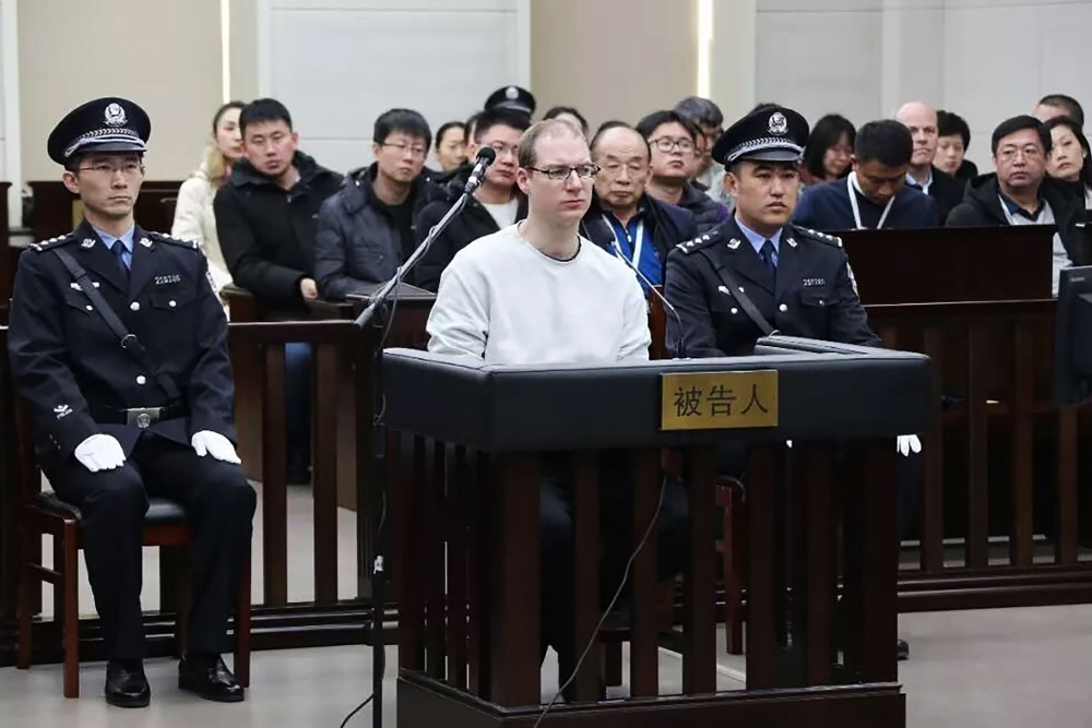 Canadian Robert Lloyd Schellenberg, center, is seen during his retrial on drug trafficking charges in the court in Dalian in China’s northeast Liaoning province on Monday. — AFP