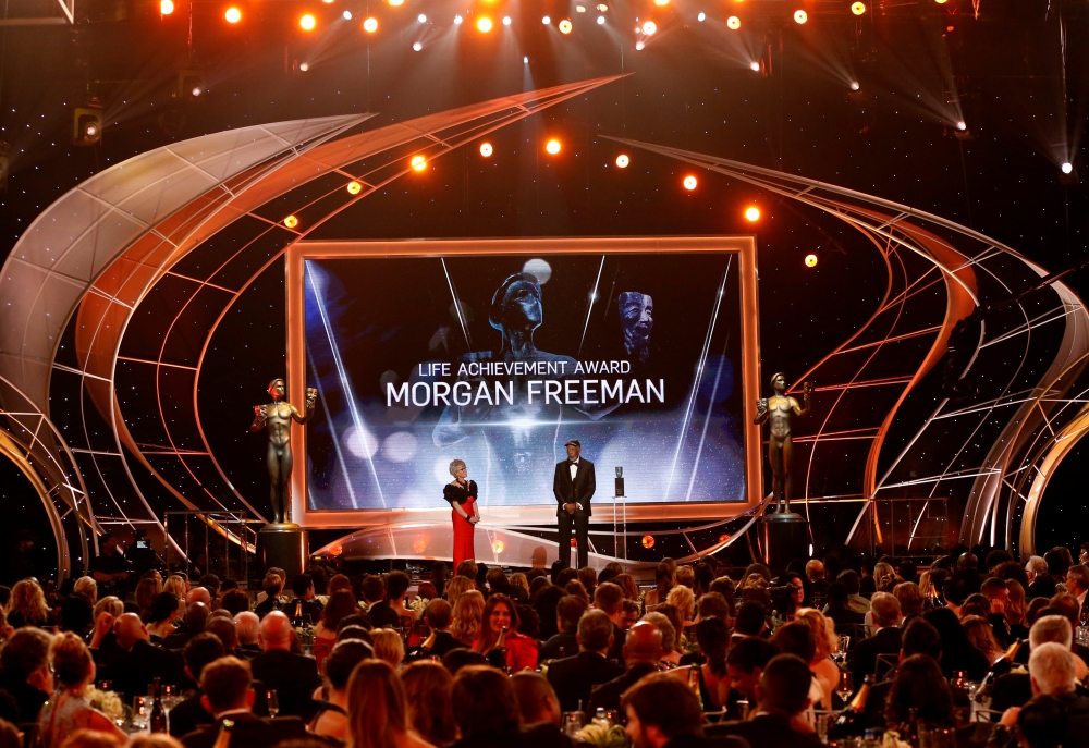 FILE PHOTO: 24th Screen Actors Guild Awards - Show - Los Angeles, California, U.S., 21/01/2018 - Actor Morgan Freeman accepts the Life Achievement Award from actress Rita Moreno. REUTERS/Mario Anzuoni/File Photo