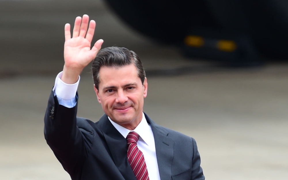 Former Mexican President Enrique Pena Nieto waves upon arrival at Ezeiza International airport in Buenos Aires province, Argentina, in this Nov. 29, 2018 photo. — AFP