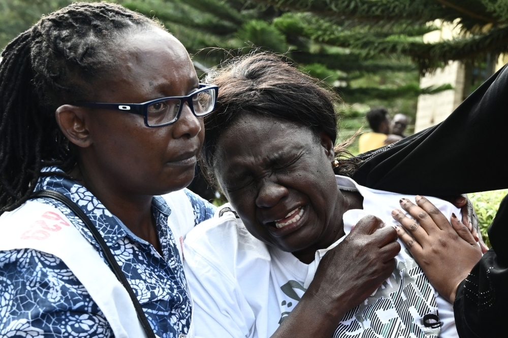 A woman cries after identifying the body of a relative at the Chiromo mortuary in Nairobi, Kenya, on Wednesday after a blast followed by a gun battle that rocked the upmarket hotel complex the day before. — AFP