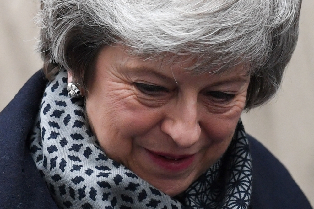 Britain’s Prime Minister Theresa May leaves 10 Downing Street in London on Wednesday ahead of Prime Minister’s Questions (PMQs) to be followed by a debate and vote on a motion of no confidence in the government. — AFP