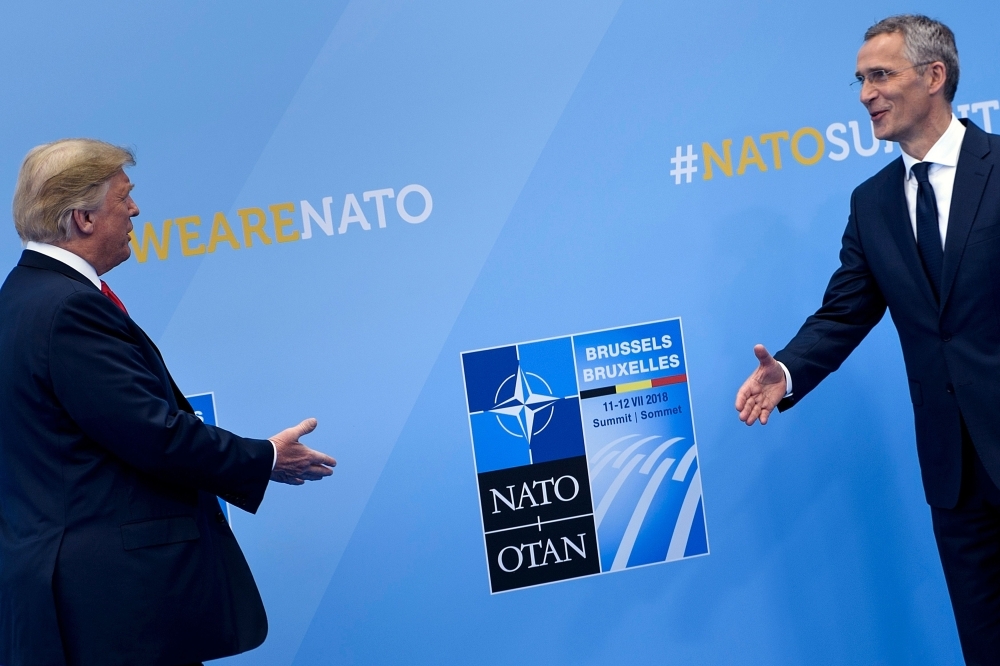 US President Donald Trump, left, is welcomed by NATO Secretary General Jens Stoltenberg on arrival to attend the NATO (North Atlantic Treaty Organization) summit in Brussels in this July 11, 2018 file photo. — AFP