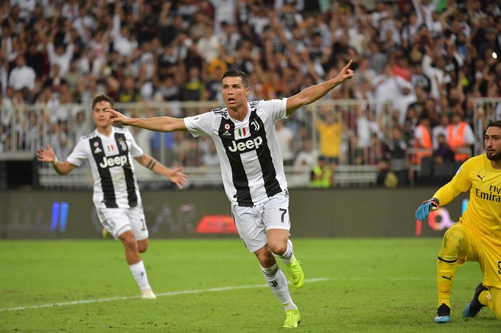 Juventus' Italian defender Giorgio Chiellini lifts the Supercoppa Italiana after winning the final against AC Milan at the King Abdullah Sports City Stadium in Jeddah Wednesday. — AFP 