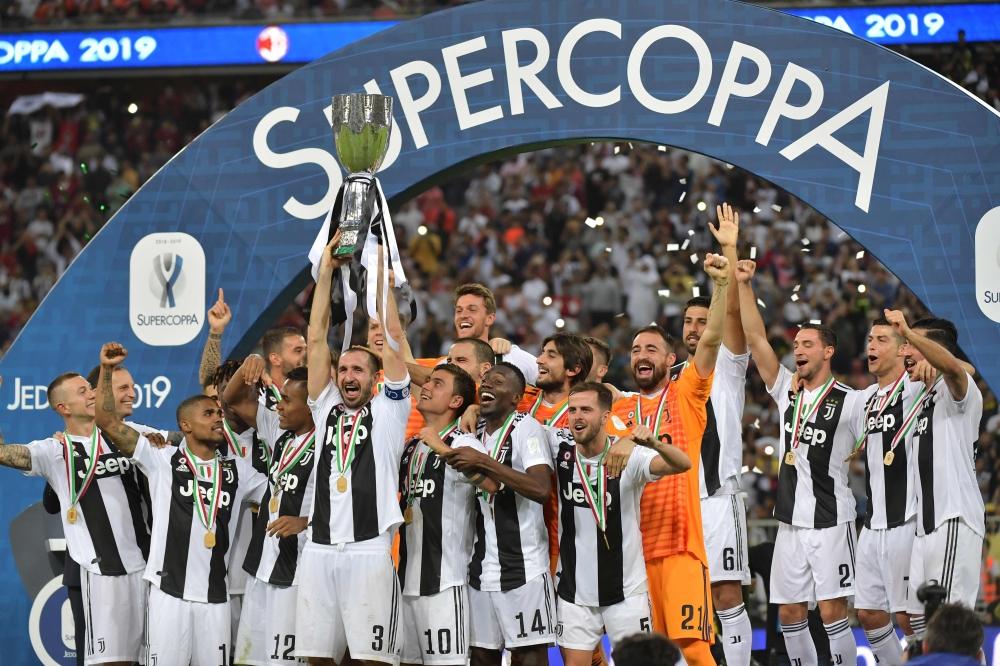 Juventus' Italian defender Giorgio Chiellini lifts the Supercoppa Italiana after winning the final against AC Milan at the King Abdullah Sports City Stadium in Jeddah Wednesday. — AFP 