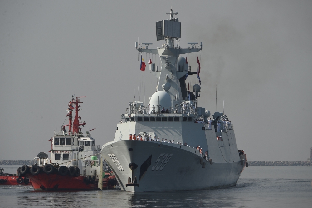 Chinese guided-missile frigate Wuhu prepares to dock at the international port in Manila on Thursday. — AFP