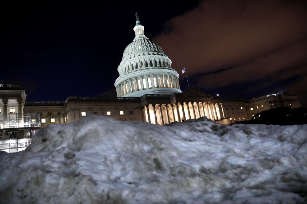 The U.S. Capitol is seen behind a snow pile in Washington, on Wednesday. — Reuters