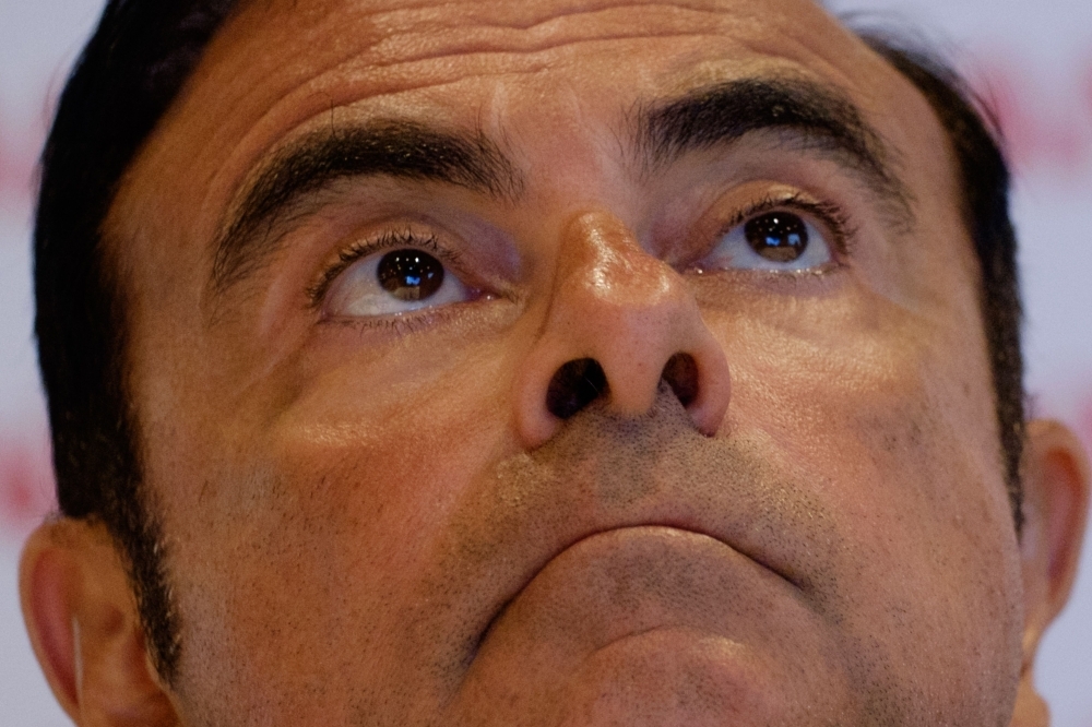 In this file photo then President and CEO of Japan's auto company Nissan Carlos Ghosn, gestures during a press conference in Rio de Janeiro. — AFP