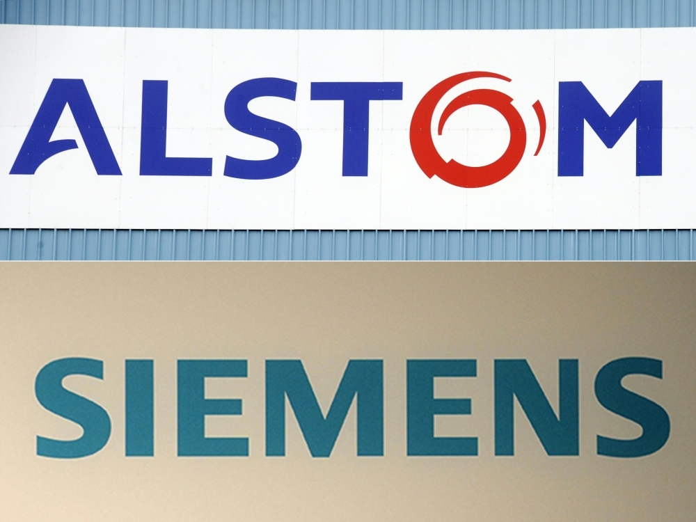 This combination of pictures shows the logo of the French power and transport engineering company Alstom and the logo of German industrial group Siemens. — AFP