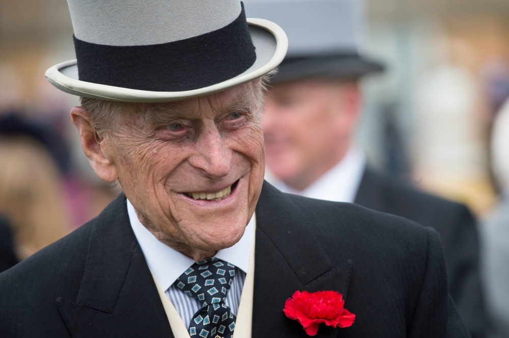 Prince Philip, Duke of Edinburgh, greets guests at a garden party at Buckingham Palace in London in this May 16, 2017 file photo. — AFP