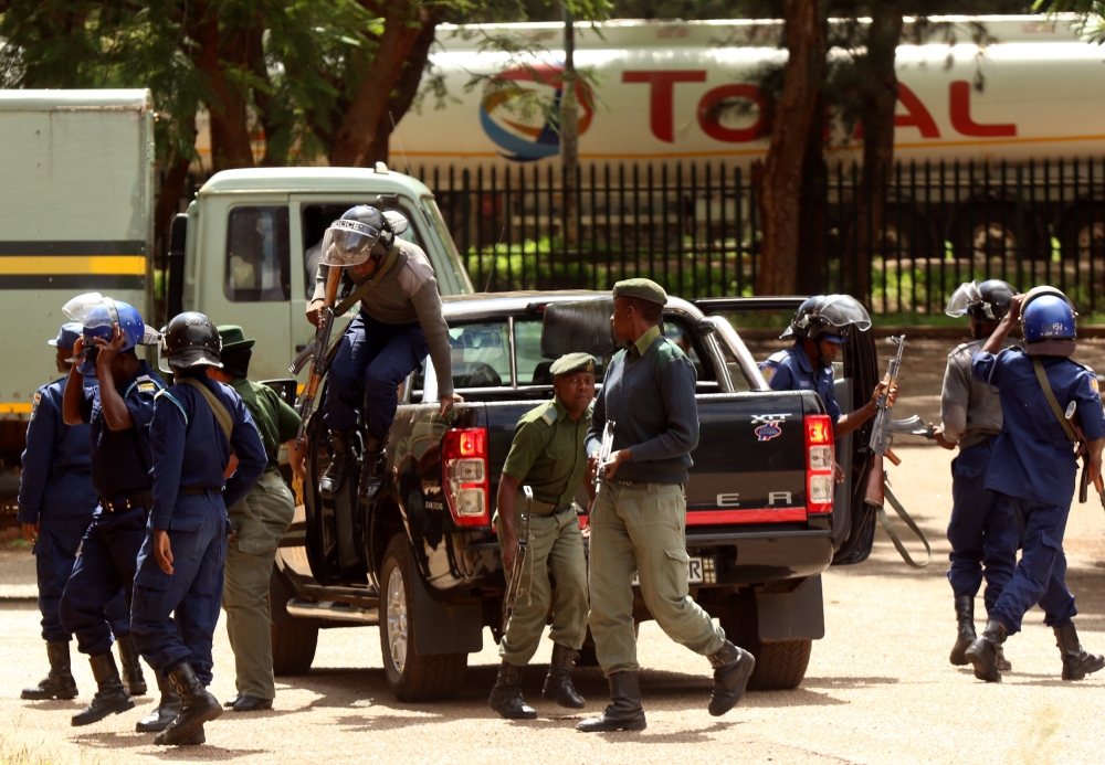 Police stand guard as people arrested during protests appeal in court in Harare, Zimbabwe, on Friday. — Reuters