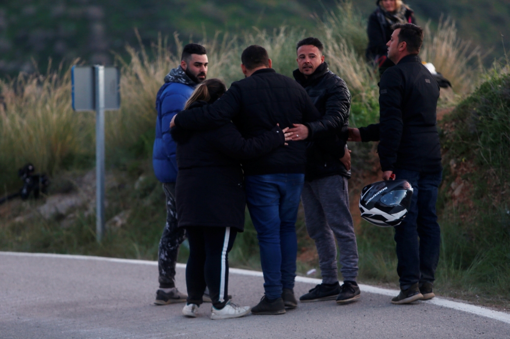 People comfort each other on a road after leaving the area where Julen, a Spanish two-year-old boy fell into a deep well four days ago when the family was taking a stroll through a private estate, in Totalan, southern Spain, on Thursday. — Reuters