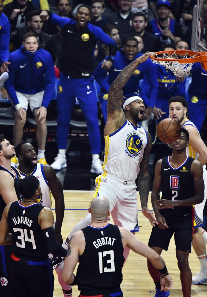 Golden State Warriors’ center DeMarcus Cousins throws down a one-handed slam dunk against the Los Angeles Clippers during their NBA game at Staples Center in Los Angeles Friday. — Reuters 