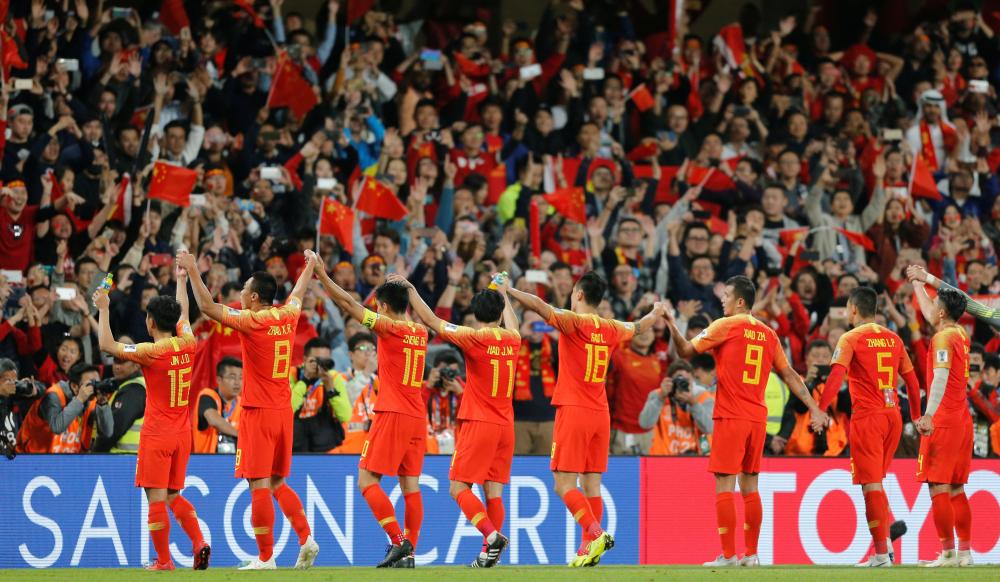 China's players celebrate at the end of the AFC Asian Cup match against Thailand at Hazza Bin Zayed Stadium in Al-Ain Sunday. — Reuters