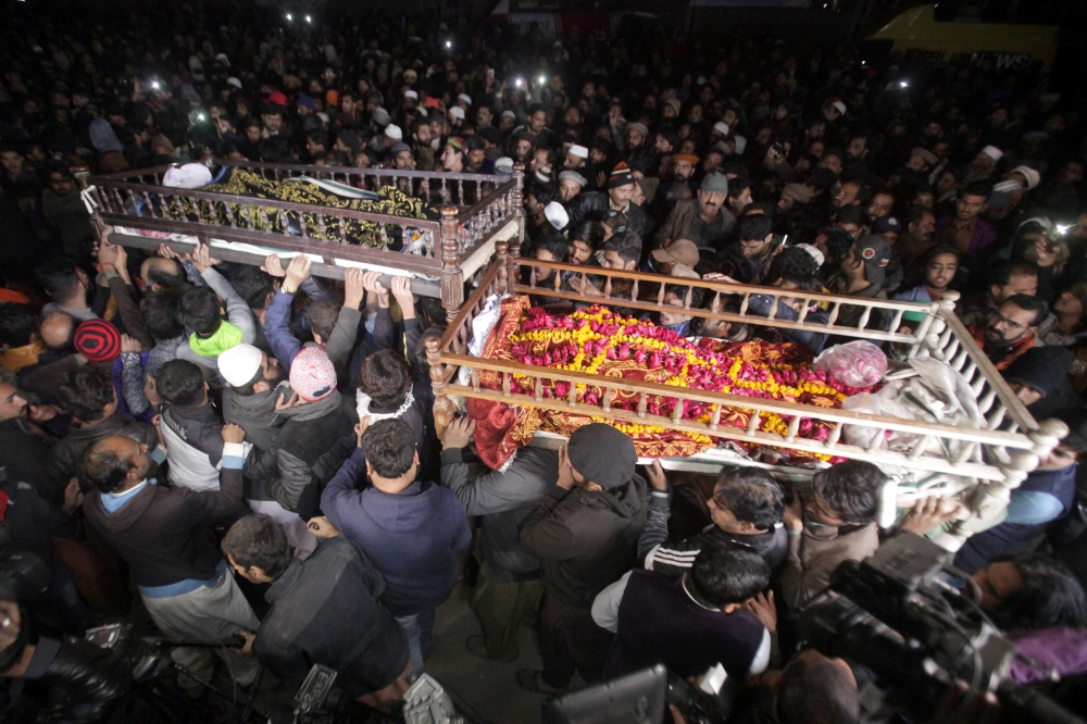 Mourners and relatives carry their family members’ bodies, who were killed by police, at their funeral in Lahore, Pakistan, on Sunday. — Reuters