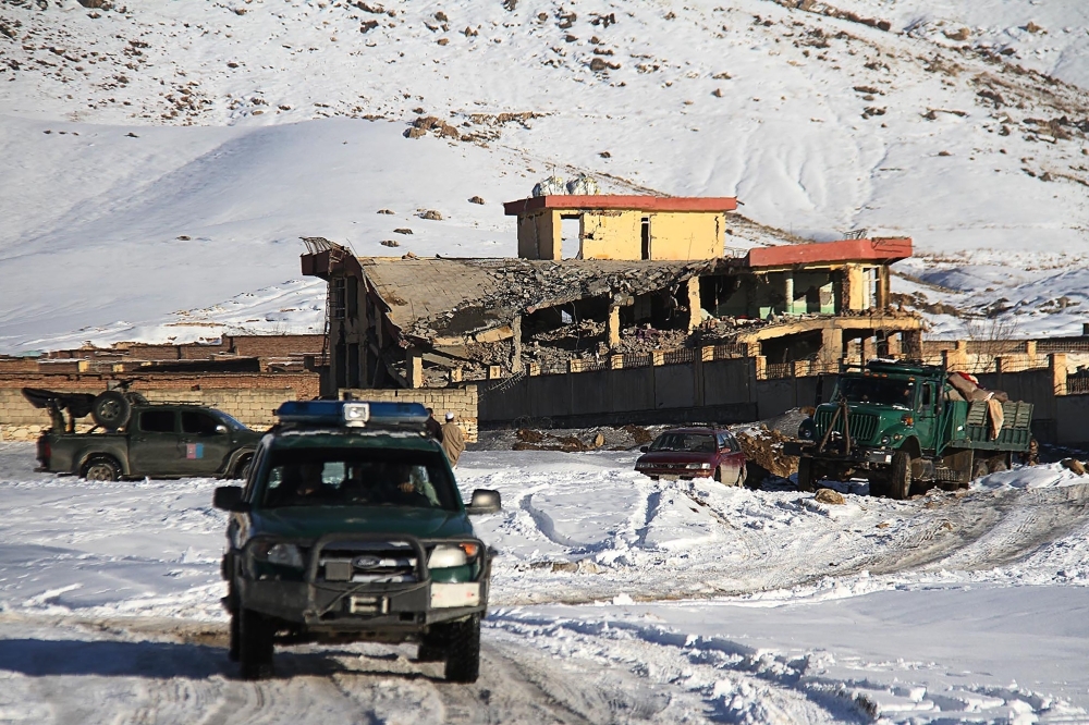 An Afghan military vehicle is seen near a site after a car bomb attack on a military base in the central province of Maidan Wardak on Monday. — AFP