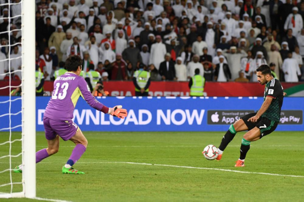 United Arab Emirates' forward Ali Mabkhout takes a shot against Kirghyzstan's goalkeeper Kutman Kadyrbekov (L) during the 2019 AFC Asian Cup Round of 16 football match between uae and Kyrgyzstan at the Zayed Sports City Stadium in Abu Dhabi on Monday. — AFP