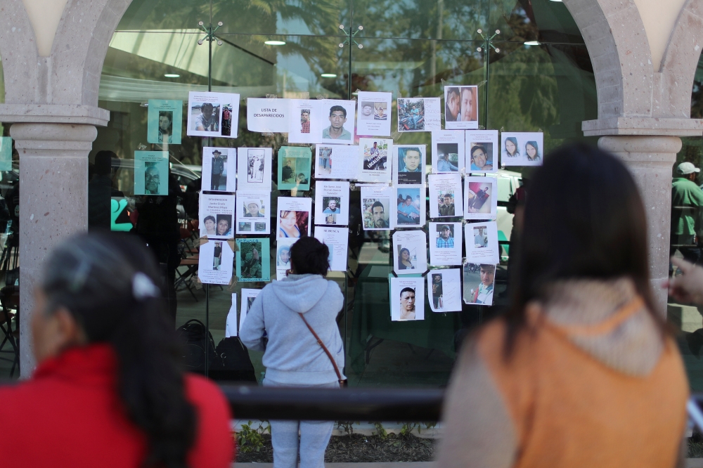 Residents look at pictures of people missing after an explosion of a fuel pipeline ruptured by oil thieves, in the municipality of Tlahuelilpan, state of Hidalgo, Mexico, on Monday. — Reuters