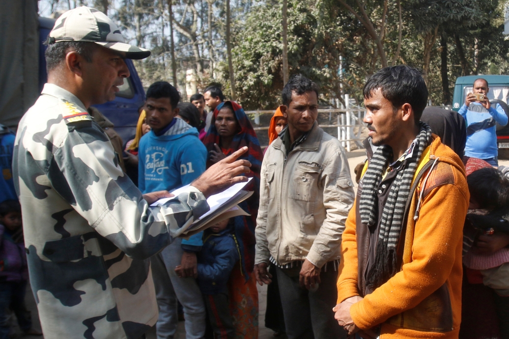 A Border Security Force (BSF) official registers the names of Rohingya Muslims after they were detained while crossing the India-Bangladesh border from Bangladesh, at Raimura village on the outskirts of Agartala, on Tuesday. — Reuters