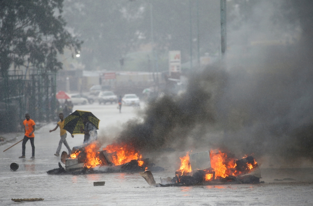 Barricades burn as rain falls during protests in Harare, Zimbabwe, in this Jan. 14, 2019 file photo. — Reuters 