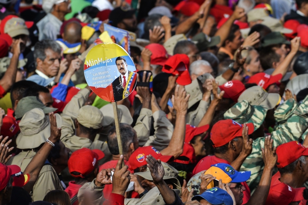 Government supporters listen to Venezuelan President Nicolas Maduro speaking at the Miraflores Palace during a rally in which he announced that his administration was breaking off diplomatic ties with the United States in Caracas on Wednesday. — AFP