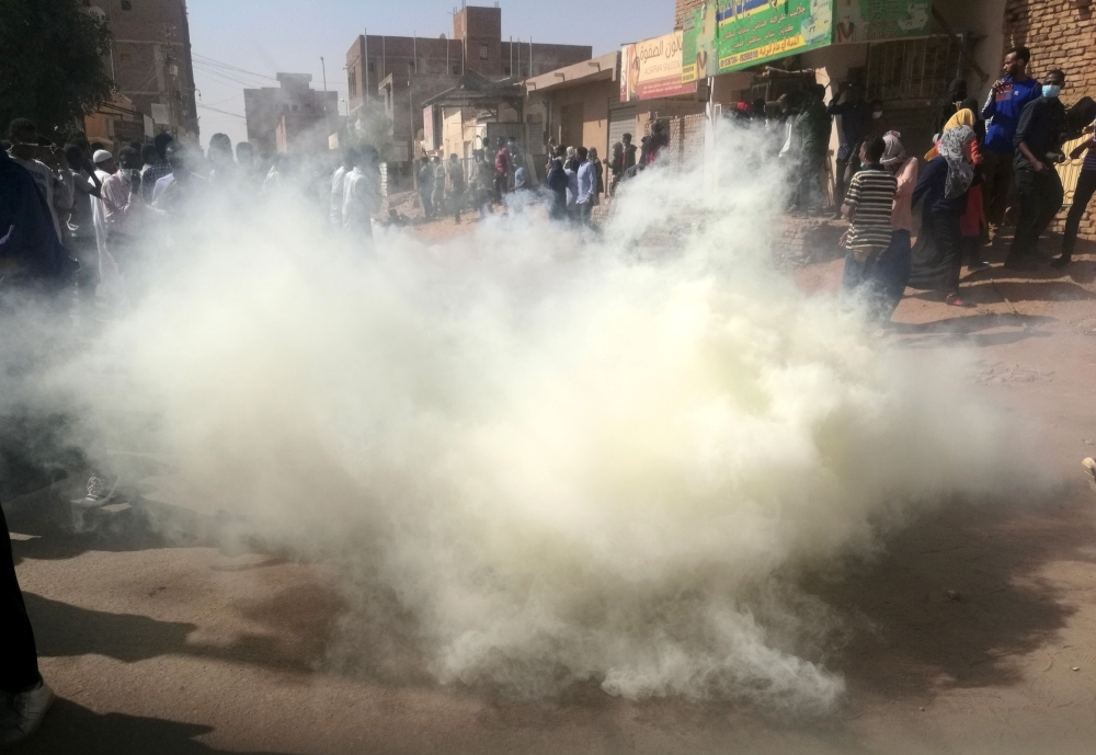 Sudanese police fire tear gas at hundreds of protesters trying to march on the presidential palace in the capital Khartoum on Thursday. — AFP