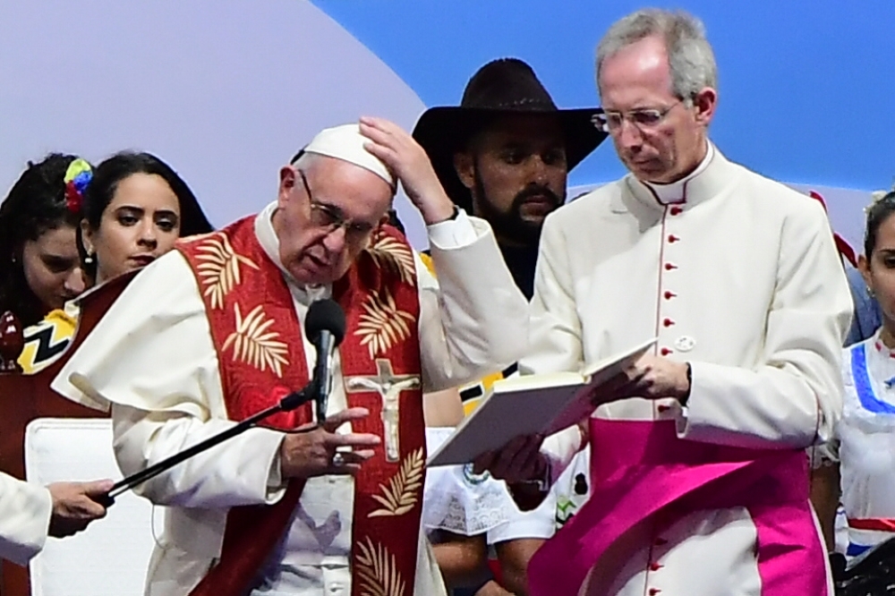 Pope Francis (L) takes part in the Via Crucis ceremony on the main highway running along Panama City's Pacific shoreline, on Friday. — AFP