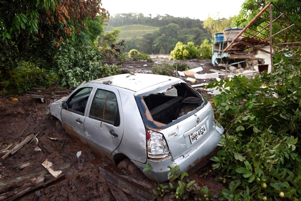 The wrackages of a car and house are seen amid the mud a day after the collapse of a dam at an iron-ore mine belonging to Brazil's giant mining company Vale, near the town of Brumadinho in the state of Minas Gerias in southeastern Brazil, on Saturday. — AFP